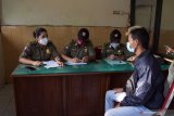 Petugas memberikan sanksi teguran dan mencatat identitas pelanggar protokol kesehatan saat operasi yustisi penegakan hukum protokol kesehaan pencegahan penularan COVID-19 di kawasan Alun-alun Kota Madiun, Jawa Timur, Selasa (13/4/2021). Operasi yang dilakukan petugas gabungan Polisi, Satpol PP dan petugas Badan Penanggulangan Bencana Daerah (BPBD) menyasar pada para pengendara yang tak menggunakan masker atau menggunakan masker namun tidak menutup seluruh hidung dan mulut guna pencegahan penularan COVID-19. Antara Jatim/Siswowidodo/zk.