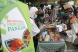 Petugas Badan Pengawasan Obat dan Makanan (BPOM) membagikan brosur mengenal pewarna makanan kepada pedagang di pasar Takjil, Kota Kediri, Jawa Timur, Kamis (15/4/2021). Sosialisasi makanan sehat tersebut guna mengedukasi pedagang agar tidak menjual makanan mengandung zat berbahaya seperti boraks, formalin, dan pewarna tekstil. Antara Jatim/Prasetia Fauzani/zk