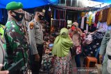 PENGAWASAN PUSAT KERAMAIAN JELANG LEBARAN. Personel gabungan Polri, TNI dan Satpol PP memberikan masker gratis kepada seorang pedagang saat pengawasan pusat keramaian di Pasar Aceh, Banda Aceh, Aceh, Kamis (6/5/2021). Polda Aceh mengintensifkan pengawasan menjelang Idul Fitri di sejumlah pusat keramaian untuk penegakan disiplin protokol kesehatan dan selain imbauan agar warga mengenakan masker dan menjaga jarak  guna mencegah penyebaran COVID-19. ANTARA FOTO/Ampelsa.