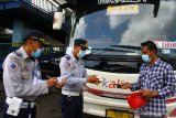 Petugas Dinas Perhubungan mengecek kelengkapan dokumen sebuah bus Antar Kota Dalam Provinsi (AKDP) berstiker khusus sebelum berangkat dari Terminal Arjosari, Malang, Jawa Timur, Jumat (7/5/2021). Pemeriksaan tersebut dilakukan untuk memastikan kelengkapan dokumen sekaligus peralatan keselamatan pada bus yang beroperasi selama larangan mudik. Antara Jatim/Ari Bowo Sucipto/zk