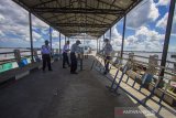 Petugas Dinas Perhubungan menutup Dermaga Feri Alalak di Banjarmasin, Kalimantan Selatan, Selasa (11/5/2021). Jalur penyeberangan kapal feri tradisional antar Kabupaten/Kota tersebut ditutup mulai tanggal 11-16 Mei 2021 guna membatasi tingginya arus keluar masuk orang dalam upaya mencegah peningkatan penyebaran COVID-19 di wilayah Kota Banjarmasin saat hari raya Idul Fitri 1442 H. Foto Antaranews Kalsel/Bayu Pratama S.