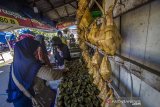 Pedagang ketupat dan lontong melayani konsumen di Kampung Ketupat Jalan Sungai Baru, Banjarmasin, Kalimantan Selatan, Rabu (12/5/2021). Menjelang Hari Raya Idul Fitri 1442 Hijriah, penjualan ketupat dan lontong yang di jual harga Rp5000 hingga Rp7000 per buah itu mengalami peningkatan hingga 75 persen dibandingkan pada hari biasa. Foto Antaranews Kalsel/Bayu Pratama S.