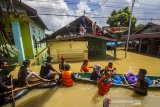 Sejumlah relawan mendistribusikan bantuan makanan kepada warga yang terdampak banjir di Jalan Biduri, Kecamatan Satui, Kabupaten Tanah Bumbu , Kalimantan Selatan, Sabtu (15/5/2021). BPBD Kabupaten Tanah Bumbu mencatat sebanyak 2.126 unit rumah di Kecamatan Satui tersebut terendam banjir setinggi 50 cm hingga dua meter akibat tingginya intensitas curah hujan yang mengakibatkan meluapnya Sungai Satui. Foto Antaranews Kalsel/Bayu Pratama S.