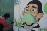 Perupa yang tergabung dalam ArtZheimer Pamekasan melukis mural dengan tema 'Indonesia Sedang Tidak Baik-Baik Saja' di Jalan Kemayoran, Pamekasan, Jawa Timur, Minggu (16/5/2021). Aksi melukis mural yang dilakukan secara serentak di sejumlah kota di Indonesia atas inisiasi Serikat Mural Surabaya itu, merupakan bentuk keprihatinan mereka terhadap kondisi bangsa Indonesia mulai dari sosial politik hingga kasus Pandemi COVID-19. Antara Jatim/Saiful Bahri/zk