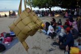 Warga menunjukkan ketupat saat tradisi Lebaran Ketupat di Pantai Sanur, Denpasar, Bali, Kamis (20/5/2021). Tradisi yang dirayakan 7 hari setelah Hari Raya Idul Fitri 1442 Hijriah tersebut untuk ajang silaturahim antar keluarga besar sekaligus sebagai simbol kebersamaan dan lambang kasih sayang. ANTARA FOTO/Nyoman Hendra Wibowo/nym.