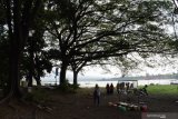 Pengunjung berada di tepi Waduk Bening Saradan, Kabupaten Madiun, Jawa Timur, Sabtu (29/5/2012). Objek wisata waduk di tepian hutan yang memiliki luas genangan 5,7 kilometer persegi dengan kapasitas efektif 25,768 juta meter kubik tersebut mulai dikunjungi wisatawan setelah selama masa pandemi COVID-19 sepi pengunjung. Antara Jatim/Siswowidodo/zk