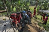 Tim Vertical Rescue Indonesia (VRI) dibantu TNI dan warga membangun jembatan gantung di Desa Cisempur, Kecamatan Cibalong, Kabupaten Tasikmalaya, Jawa Barat, Minggu (6/6/2021). Data VRI mencatat pihaknya telah membangun 1.024 jembatan perintis di seluruh pelosok nusantara dalam rangkaian Ekspedisi 1.000 Jembatan Gantung untuk Indonesia yang dibangun secara gotong royong bersama masyarakat. ANTARA FOTO/Adeng Bustomi/agr