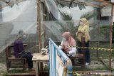 Warga membezuk sejawatnya yang dikarantina di Rumah Sakit Darurat COVID-19 Tulungagung, Tulungagung, Jawa Timur, Rabu (23/6/2021). Lonjakan kasus akibat munculnya klaster Latsar ASN yang berjumlah 78 orang menyebabkan RSDC berkapasitas 120 bed di kompleks Rusunawa UIN SATU Tulunggung ini penuh. Antara Jatim/Destyan Sujarwoko/zk