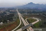 Foto udara proyek Jalan Tol Cileunyi-Sumedang-Dawuan (Cisumdawu) di Pamulihan, Kabupaten Sumedang, Jawa Barat, Senin (28/6/2021). Untuk mengejar target rampungnya proyek Jalan Tol Cisumdawu pada Desember 2021 mendatang, Menteri PUPR Basuki Hadimuljono menginstruksikan agar ada penambahan kontraktor proyek tersebut yang memiliki panjang  60,10 kilometer. ANTARA FOTO/Raisan Al Farisi/agr