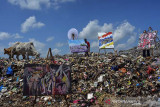 Sejumlah seniman dari Komunitas Cermin memajang hasil lukisannya ditumpukan sampah dalam acara Ngaruat Kemerdekaan RI ke-76 di Tempat Pembuangan Akhir Sampah (TPAS) Cianggir, Kota Tasikmalaya, Jawa Barat, Minggu (15/8/2021). Sebanyak tujuh pelukis menuangkan kritik melalui lukisan untuk merespon kondisi lingkungan dan sampah serta hasil lukisannya akan dilelang dan didonasikan untuk warga terdampak pandemi COVID-19. ANTARA FOTO/Adeng Bustomi/agr