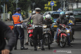 Petugas Kepolisian memberhentikan kendaraan saat pemberlakuan ganjil genap di Cikapayang, Bandung, Jawa Barat, Jumat (20/8/2021). Pemerintah Kota Bandung bersama Polrestabes Bandung memperpanjang pemberlakuan ganjil genap hingga 23 Agustus guna menekan mobilitas masyarakat di masa perpanjangan PPKM Level 4. ANTARA FOTO/Raisan Al Farisi/agr