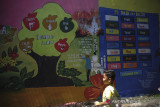 Seorang anak melintas di samping dinding yang dihias oleh mural yang bertemekan keagamaan di Kampung Kukun Endah, Desa Cikoneng, Kabupaten Bandung, Jawa Barat, Kamis (26/1/2021). Warga berinisiatif untuk menghias dinding dengan tema keagaaman guna memberikan edukasi pada anak tentang ilmu keagamaan serta menjaga dinding dari coretan vandalisme. ANTARA FOTO/Raisan Al Farisi/agr