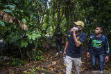 Ketua Serikat Petani Indonesia (SPI) Kalimantan Selatan Dwi Putera Kurniawan (tengah) bersama warga dan mahasiswa Fakultas Pertanian ULM melihat tanaman kopi yang tumbuh di Pegunungan Meratus di Desa Tilahan, Hulu Sungai Tengah, Kalimantan Selatan, Kamis (26/8/2021). SPI Kalimantan Selatan merencanakan Kabupaten Hulu Sungai Tengah menjadi pusat pengembangan tanaman kopi di Kalimantan Selatan dengan menyiapkan 100 ribu bibit kopi yang akan di tanam di desa-desa pedalaman sebagai upaya peningkatan ekonomi masyarakat, hingga saat ini pihak SPI Kalsel telah menemukan tiga jenis tanaman kopi yang tumbuh di wilayah Pegunungan Meratus yaitu jenis kopi Robusta, Liberika dan Ekselsa. Foto Antaranews Kalsel/Bayu Pratama S.