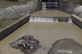 Foto udara suasana prosesi Tradisi Ruwatan Sungai Cilamaya di Bendungan Barugbug, Jatisari, Karawang, Jawa Barat, Rabu (22/9/2021). Kegiatan tersebut diselenggarakan oleh Forum Daerah Sungai (Fordas) Cilamaya Berbunga sebagai ungkapan rasa syukur dan keberkahan yang diberikan Tuhan atas air yang mengalir dari sungai Cilamaya melalui Kabupaten Purwakarta, Subang dan Karawang untuk kehidupan masyarakat. ANTARA FOTO/M Ibnu Chazar/agr