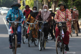 Sejumlah anggota komunitas sepeda tua Senopati dengan berpakaian batik mengayuh sepedanya di Jalan Darmo, Surabaya, Jawa Timur, Minggu (3/10/2021). Kegiatan bersepeda bersama menyusuri jalan dengan mengenakan busana batik itu dalam rangka menyemarakkan Hari Batik Nasional. Antara Jatim/Didik Suhartono/zk.