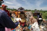 PEMBAGIAN MAKANAN BAGI PEMULUNG. Warga membagikan nasi kotak kepada pemulung di tempat pembuangan akhir (TPA) Alue Lim Lhokseumawe, Aceh, Jumat (8/10/2021). Pembagian makanan gratis tersebut untuk membantu meringankan beban ekonomi masyarakat sebagai bentuk kepedulian terhadap sesama di tengah pandemi COVID-19. ANTARA/Rahmad