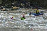 Peserta berselancar melewati jeram arus pada Jambore Nasional Riverbording #3 di Sungai Ciwulan, Kawalu, Kota Tasikmalaya, Jawa Barat, Minggu (10/10/2021). Jambore Nasional Riverbording yang diikuti oleh ratusan pehobi selancar sungai dari berbagai daerah dalam rangka silahturahmi tersebut bertujuan untuk mempromosikan wisata Sungai Ciwulan, mengampanyekan sungai untuk dijaga kelestariannya dan meningkatkan ekonomi warga setempat. ANTARA FOTO/Adeng Bustomi/agr