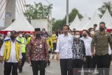 Presiden Joko Widodo (tengah) didampingi Menteri PUPR Basuki Hadimuljono (kiri), Menteri BUMN Erick Thohir (dua kanan), Gubernur Kalimantan Selatan Sahbirin Noor (dua kiri) dan Wali Kota Banjarmasin Ibnu Sina (tiga kanan) berjalan meninjau jembatan Sungai Alalak di Banjarmasin, Kalimantan Selatan, Kamis (21/10/2021). Dalam kunjungan kerja di Kalimantan Selatan, Presiden Joko Widodo melakukan serangkaian kegiatan seperti peresmian pabrik biodiesel level B30 di Kabupaten Tanah Bumbu, meninjau pelaksanaan vaksinasi COVID-19 di RS Anshari Saleh dan peresmian Jembatan Sungai Alalak di Banjarmasin. Foto Antaranews Kalsel/Bayu Pratama S.