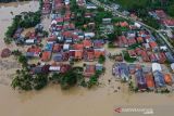 Foto udara suasana permukiman warga yang terendam banjir di Desa Karangligar, Karawang, Jawa Barat, Jumat (5/11/2021). Banjir yang melanda di wilayah itu disebabkan meluapnya air sungai Cibeet karena tingginya intensitas hujan yang mengakibatkan ratusan rumah terendam banjir. ANTARA FOTO/M Ibnu Chazar/agr