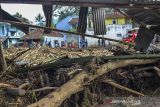 Sejumlah warga membersihkan lumpur sisa banjir bandang di Kampung Cilowa, Kecamatan Sukawening, Kabupaten Garut, Jawa Barat, Minggu (28/11/2021). Hujan dengan intensitas tinggi yang mengguyur Kabupaten Garut menyebabkan sungai Citameng meluap dan menerjang dua kecamatan yaitu Karang Tengah dan Sukawening. ANTARA FOTO/Adeng Bustomi/agr