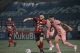 Pesepak bola Bali United Ilija Spasojevic (tengah) berebut bola dengan pesepak bola Madura United Jaimerson dalam pertandingan lanjutan Liga 1 di Bantul, Yogyakarta, Kamis (9/12/2021). Bali United kalah dari Madura United dengan skor 0-1. Bali Antaranews/Bali United/nym.