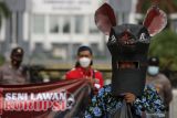 Sekelompok orang menggelar aksi teatrikal dengan mengenakan topeng kepala tikus, di Surabaya, Jawa Timur, Kamis (9/12/2021). Aksi yang mendukung pemberantasan korupsi itu untuk memperingati Hari Anti Korupsi Sedunia. Antara Jatim/Didik Suhartono/ZK