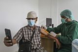 Seorang lansia melakukan swafoto saat vaksinasi lanjutan (booster) dengan jenis pfizer di Sentra Vaksinasi RSUI, Depok, Jawa Barat, Rabu (12/1/2022). Pemerintah Kota Depok memulai program vaksinasi lanjutan (booster) COVID-19 kepada masyarakat umum berusia 18 tahun ke atas dengan prioritas penerima orang lanjut usia (lansia) secara gratis. ANTARA FOTO/Asprilla Dwi Adha/YU