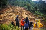 Warga menyaksikan tanah longsor di Desa Ciherang, Sumedang Selatan, Kabupaten Sumedang, Jawa Barat, Minggu (16/1/2022). Longsor dari tebing setinggi 150 meter pada Sabtu (15/1/2022) itu mengakibatkan dua hektare lahan persawahan tertimbun tanah dan warga satu RT di dusun tersebut terpaksa mengungsi. ANTARA FOTO/Raisan Al Farisi/agr