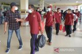 Sejumlah nelayan Provinsi Aceh mengenakan kostum merah menuju ruang tunggu saat tiba di Bandara Internasional Sultan Iskandar Muda, Blang Bintang, Kabupaten Aceh Besar, Aceh, Jumat (4/2/2022). Sebanyak 28 nelayan asal Aceh yang ditahan di Thailand dalam kasus pelanggaran teritorial  itu dipulangkan ke Indonesia setelah mendapat pengampunan dari kerajaan Thailand pada kesempatan ulang tahun Yang Mulia Raja Rama X . ANTARA FOTO/Ampelsa