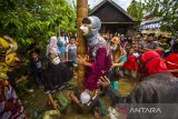 Warga memanjat pinang dengan kesenian Bapantul (Menggunakan Topeng) saat Tradisi Pengantin Banjar Di Kecamatan Haruyan, Kabupaten Hulu Sungai Tengah, Kalimantan Selatan, Senin (21/2/2022). Tradisi pengantin tersebut menampilkan berbagai macam seni dan budaya seperti Bearak Naga, Bausung Pengantin, berbalas pantun dan Bapantul yang merupakan adat istiadat suata perkawinan di Kalimantan Selatan serta melestarikan tradisi turun temurun adat Banjar. Foto Antaranews Kalsel/Bayu Pratama S.