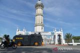 Anggota Polri menggunakan kendaraan taktis water cannon menyemprotkan cairan disinfektan menjelang shalat Jumat di area Masjid Raya Baiturrahman, Banda Aceh, Aceh, Jumat (4/3/2022). Penyemprotan dilakukan untuk mencegah penyebaran varian baru COVID-19 yakni B.1.1.529 atau Omicron. ANTARA FOTO/Ampelsa.