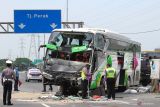 Polisi melakukan pemeriksaan di lokasi kecelakan bus pariwisata dengan truk di Tol Dupak - Tanjung Perak Surabaya, Jawa Timur, Sabtu (5/3/2022). Kecelakaan antara bus pariwisata bernopol D 7610 AT yang memuat rombongan peziarah dengan truk 'Colt Diesel' nomor polisi W 9948 Z itu diduga disebabkan salah satu penumpang bus merebut kendali kemudi dari sopir bus dan menabrak truk 'Colt Diesel' dari arah berlawanan. Dalam kecelakaan itu sopir truk dan kernetnya meninggal di lokasi kecelakaan. Antara Jatim/Didik Suhartono/zk