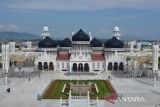 Pekerja memotong rumput di halaman Masjid Raya Baiturrahman, Banda Aceh, Aceh, Sabtu (26/3/2022). Kantor Wilayah Kementerian Agama Aceh mengimbau pengurus masjid dan musala menyesuaikan waktu ibadah shalat yang berlaku secara lokal di masing masing kabupaten/kota provinsi Aceh untuk keseragaman beribadah selama bulan suci Ramadhan 1443 Hijriah. ANTARA FOTO/Ampelsa