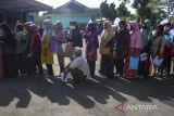 Warga mengantre saat pencairan Bantuan Langsung Tunai (BLT) minyak di GOR Kelurahan Sindangrasa, Kabupaten Ciamis, Jawa Barat, Kamis (14/4/2022). Pemerintah memberikan BLT minyak goreng sebesar Rp300 ribu per Keluarga Penerima Manfaat (KPM) untuk tiga bulan dari April sampai Juni 2022 dan bantuan sembako senilai Rp200 ribu. ANTARA FOTO/Adeng Bustomi/agr