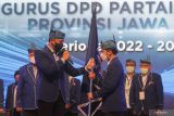 Ketua Umum Partai Demokrat Agus Harimurti Yudhoyono (AHY) (kiri) menyerahkan bendera pataka kepada Ketua DPD Partai Demokrat Jawa Timur Emil Elestianto Dardak (kanan) saat pelantikan pengurus DPD Partai Demokrat Jawa Timur di Surabaya, Jawa Timur, Jumat (22/4/2022). Pengukuhan dan pelantikan DPD Partai Demokrat Jawa Timur tersebut sebagai salah satu upaya partai berlambang bintang mecy dalam penguatan politik menjelang Pemilihan Umum 2024. Antara Jatim/Moch Asim/zk.