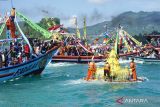 Warga mengiringi prosesi Labuh Laut/Larung Sembonyo dengan menumpang perahu nelayan yang beroperasi di Pelabuhan Perikanan Nusantara (PPN) Prigi, Trenggalek, Jawa Timur, Sabtu (18/6/2022). Prosesi adat dengan ritual melarung sesaji ke tengah laut itu ramai diikuti warga dan wisatawan yang 'haus' hiburan dan tontotan pascapebatasan sosial selama pandemi COVID-19, dua tahun terakhir. ANTARA Jatim/Destyan Sujarwoko/zk