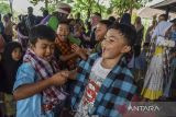 Anak - anak mengikuti permainan tradisional (Kaulinan Barudak) di Kampung Ramah Anak Leuwianyar, Kota Tasikmalaya, Jawa Barat, Sabtu (23/7/2022). Pentas kreativitas anak dalam rangka memperingati Hari Anak Nasional yang diselenggarakan oleh Komunitas Badut Tasikmalaya (Battik) dan Budak Capetang diisi berbagai kesenian diantaranya tari kreasi, pantomim, dongeng nusantara, penanaman pohon dan permainan tradisional. ANTARA FOTO/Adeng Bustomi/agr