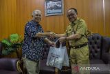 Bupati Kabupaten Tabalong Anang Syakhfiani (kanan) menerima bingkasan dari Kepala LKBN ANTARA Biro Kalimantan Selatan Nurul Aulia Badar (kiri) saat silaturahmi di Kabupaten Tabalong, Kalimantan Selatan, Senin (26/9/2022). Kunjungan tersebut dalam rangka silaturahmi sekaligus upaya meningkatkan kerja sama di bidang pemberitaan. Foto Antaranews Kalsel/Bayu Pratama S.