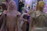 Karyawan menata busana pengantin yang dipajang dalam pameran bertajuk Serba-Serbi Manten di hall Malang Olympic Garden, Jawa Timur, Jumat (13/1/2023). Pameran jasa pernikahan yang berlangsung selama tiga hari tersebut diadakan untuk membangkitkan kembali bisnis jasa pernikahan pasca dicabutnya Pemberlakuan Pembatasan Kegiatan Masyarakat (PPKM). ANTARA Jatim/Ari Bowo Sucipto/zk 