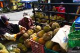 Pasar Durian Musiman di Madiun. Pedagang buah durian melayani pembeli di area pasar musiman di Pagotan, Kabupaten Madiun, Jawa Timur, Minggu (29/1/2023). Sejumlah pedagang musiman memanfaatkan areal tersebut untuk menawarkan durian hasil produksi petani lereng Gunung Wilis dengan harga Rp25 ribu-Rp200 ribu per buah. Antara Jatim/Siswowidodo/zk