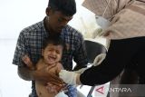 Petugas kesehatan memberikan vaksin campak (rubella) dan vitamin A kepada anak imigran etnis Rohingya yang baru ditempatkan di penampungan sementara UPTD Rumoh Sejahtera Dinas Sosial, Desa Ladong, Kabupaten Aceh Besar, Aceh, Jumat (24/2/2023). Sebanyak 69 imigran etnis Rohingya yang baru ditempatkan di penampungan sementara itu, terdiri dari anak anak anak sebanyak 20 orang mendapatkan vaksin campak dan vitamin A, sedangkan imigran dewasa berjumlah 49 orang menjalani pemeriksaan kesehatan .ANTARA FOTO/Ampelsa.