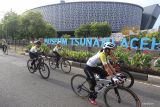 Pembalap memacu kecepatan saat mengikuti sepeda santai acara Tour De Aceh 2023 di jalan depan Museum Tsunami Aceh, Banda Aceh, Aceh, Sabtu (11/3/2023). Antara Aceh/Khalis Surry