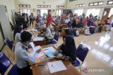 Petugas memeriksa data calon jamaah haji saat pelayanan pembuatan paspor di Kantor Kemenag Sidoarjo, Jawa Timur, Selasa (14/3/2023). Imigrasi Surabaya melakukan proses foto dan wawancara kepada 480 CJH asal Kabupaten Sidoarjo dengan cara jemput bola untuk penerbitan paspor keberangkatan ibadah haji. ANTARA Jatim/Umarul Faruq/zk 