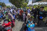 Relawan mengisikan bensin gratis yang dibagikan kepada Jamaah Puncak Haul ke-217 Maulana Syekh Muhammad Arsyad Al Banjary (Datu Kalampayan) di Desa Dalam Pagar Ulu, Kabupaten Banjar, Kalimantan Selatan, Kamis (27/4/2023). Sebanyak 2 ribu liter bensin jenis pertalite dibagikan relawan secara gratis kepada jamaah haul yang hadir pada Peringatan Haul Datu Kalampayan tersebut. ANTARA/Bayu Pratama S.