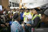 Menteri Agama Yaqut Cholil Qoumas (kelima kiri) bersama Gubernur Jawa Barat Ridwan Kamil (tengah) berbincang dengan jamaah calon haji saat penerbangan perdana di bandara BIJB Kertajati, Majalengka, Minggu (28/5/2023). malam. Sebanyak 366 calon haji asal Kabupaten Majalengka mulai diberangkatkan ke Mekah melalui bandara Kertajati. ANTARA FOTO/Dedhez Anggara/agr 
