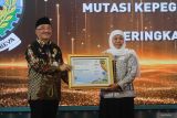 Gubernur Jawa Timur Khofifah Indar Parawansa (kanan) menerima piagam penghargaan dari Plt Kepala Badan Kepegawaian Negara (BKN) Bima Haria Wibisana (kiri) saat Penganugerahan BKN Award 2023 di Surabaya, Jawa Timur, Kamis (8/6/2023). Pemerintah Provinsi Jawa Timur dan Pemerintah Kabupaten/Kota se-Jawa Timur memborong sebanyak 39 penghargaan dari berbagai ketegori dalam ajang BKN Award 2023 yang merupakan upaya meningkatkan manajemen ASN untuk memberikan pelayanan terbaik kepada masyarakat. Antara Jatim/Moch Asim/zk.