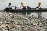 Karyawati PLN Unit Pelaksana Pelayanan Pelanggan (UP3) Lhokseumawe mengambil sampah dengan menggunakan perahu saat aksi bersih sampah PLN Peduli di waduk  Lhokseumawe, Aceh. Jumat (9/6/2023). Aksi bersih sampah PLN Peduli tersebut merupakan program Tanggung Jawab Sosial Lingkungan (TJSL)  dalam rangka memperingati Hari Lingkungan Hidup Sedunia. ANTARA/Rahmad