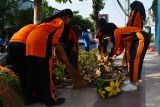 Sejumlah pelajar SMP memungut sampah di kawasan trotoar Kota Madiun, Jawa Timur, Jumat (16/6/2023). Aksi bersih-bersih lingkungan tersebut dalam rangka peringatan Hari Lingkungan Hidup Sedunia dan Hari Jadi ke-105 Kota Madiun. Antara Jatim/Siswowidodo/zk.