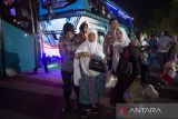 Petugas membantu jamaah haji kloter 15 turun dari bus saat tiba di debarkasi Kertajati, di Indramayu, Jawa Barat, Minggu (23/7/2023). Berdasarkan data Panitia Penyelenggara Ibadah Haji (PPIH) Debarkasi Kertajati per (23/7) malam, kepulangan jamaah haji sebanyak 5.586 dari 15 kloter. ANTARA FOTO/Dedhez Anggara/agr
