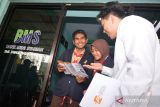 Seorang pegawai Lembaga Penjamin Simpanan (LPS) memberikan edukasi tentang LPS ke siswa di Bank Mini Syariah SMK Zainul Hasan, Balung, Jember, Jawa Timur, Jumat (18/8/2023). Lembaga Penjamin Simpanan (LPS) memberikan edukasi kepada lembaga pendidikan dan pelajar yang menjadi nasabah bank untuk menyimpan uang di lembaga keuangan yang dijamin oleh LPS. ANTARA Jatim/Seno/ZK